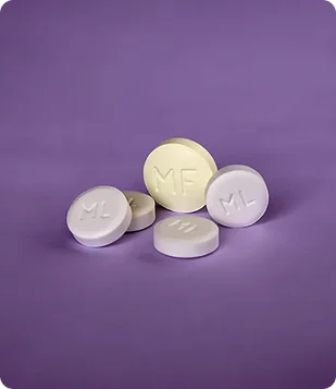 Mifepristone and misoprostol pills displayed on a purple background representing medical abortion training course content.